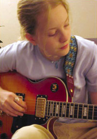 Abigail Copeland demonstrates electric guitar technique