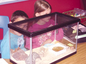 Aaron and Abby with the class aquarium