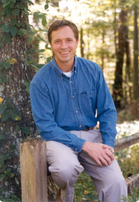 Jeff Myers sitting in forest