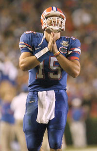 im Tebow strikes a prayerful pose after throwing a touchdown pass